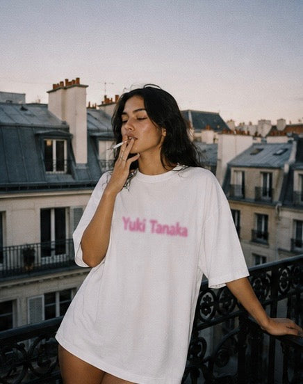 White oversized T-shirt with a blurred pink graphic